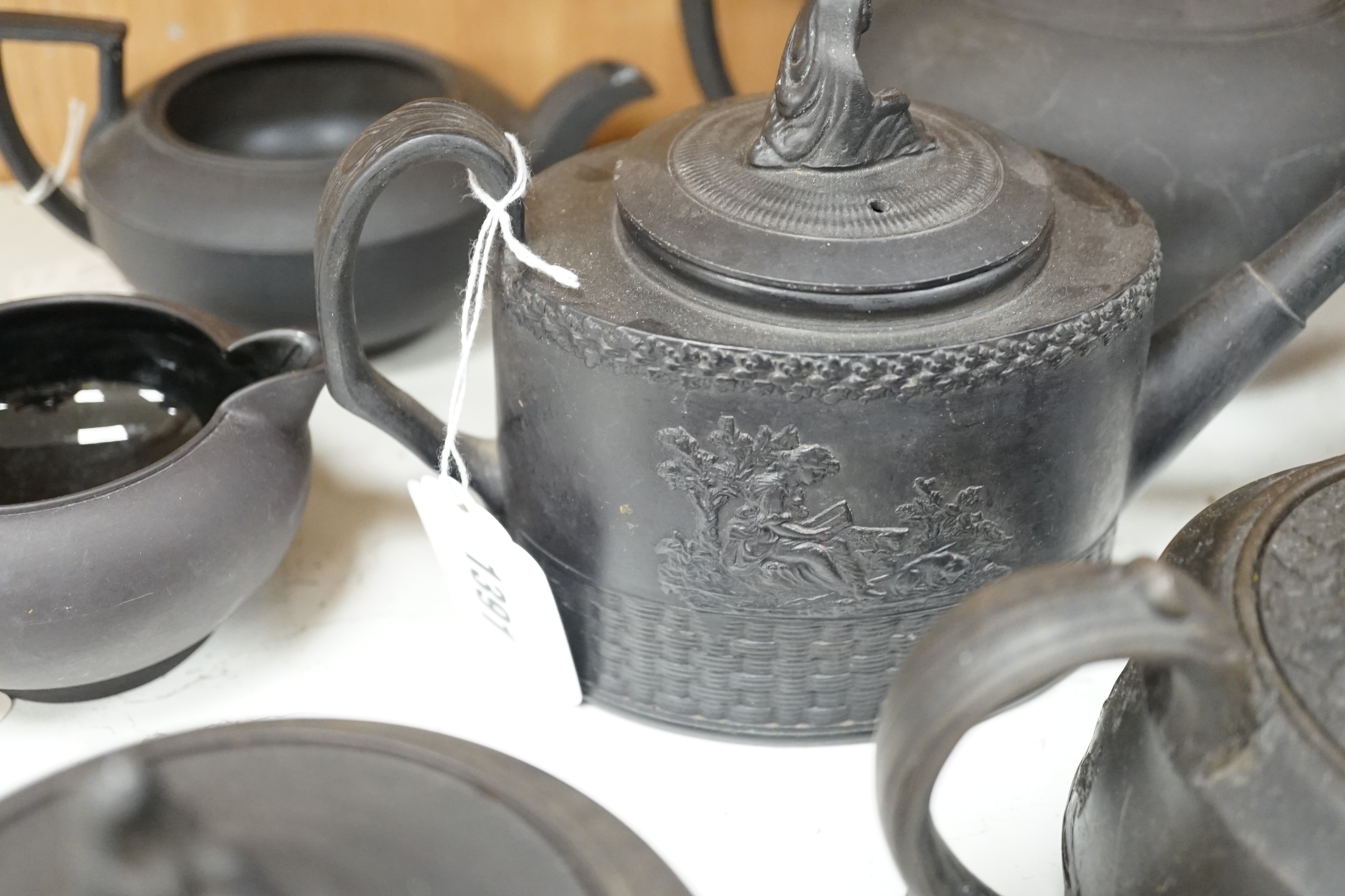 A collection of Wedgwood and other black basalt teapots and tea wares, 19th/early 20th century, tallest teapot 17cms high